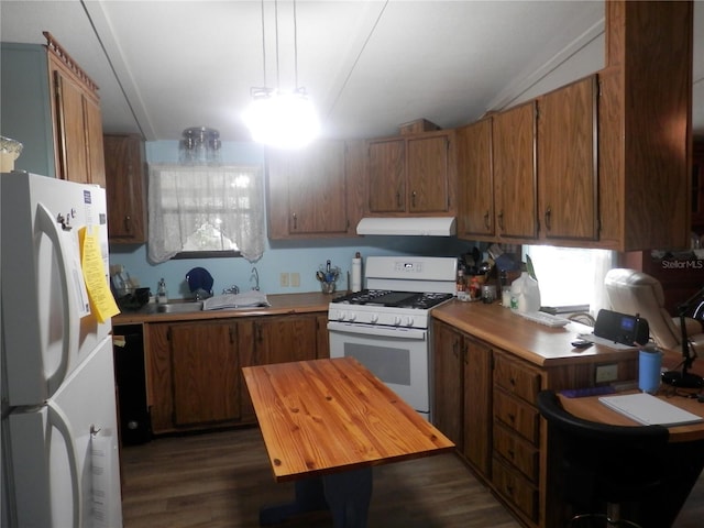 kitchen with vaulted ceiling, dark wood-type flooring, and white appliances