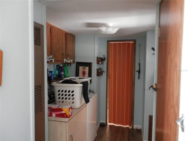 laundry area with independent washer and dryer, cabinets, and wood-type flooring