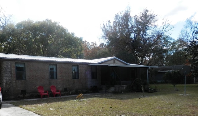 rear view of house featuring a yard