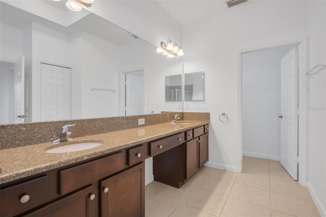 bathroom with tile patterned flooring and vanity