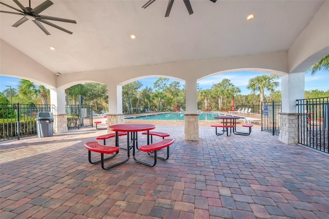 view of patio with ceiling fan and a community pool