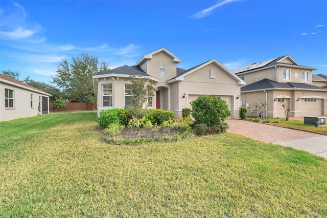 view of front of home with a garage and a front yard