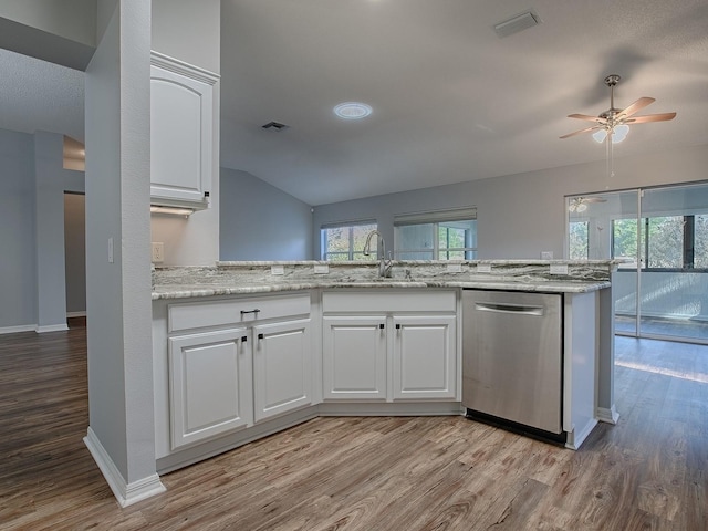 kitchen featuring sink, white cabinetry, light stone counters, light wood-type flooring, and stainless steel dishwasher