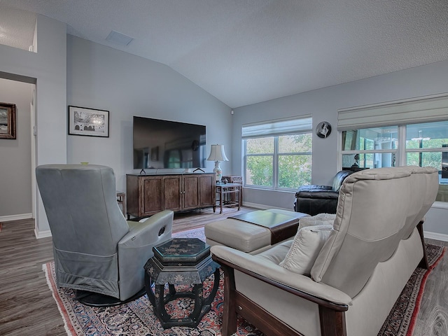 living room with lofted ceiling, dark wood-type flooring, and a textured ceiling