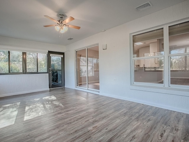 unfurnished room featuring hardwood / wood-style flooring and ceiling fan