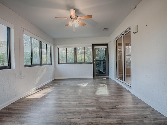 unfurnished sunroom featuring plenty of natural light and ceiling fan