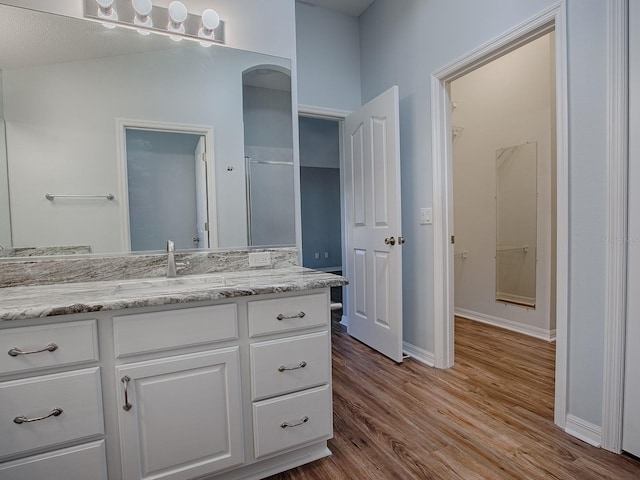 bathroom featuring vanity and hardwood / wood-style floors