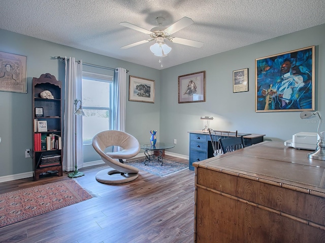 office area featuring ceiling fan, wood-type flooring, and a textured ceiling