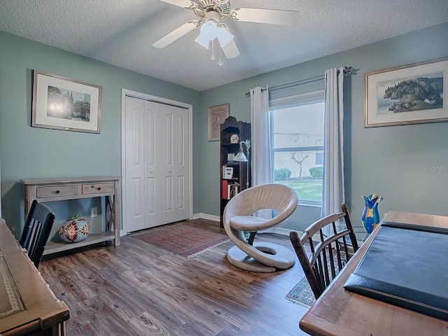 office with hardwood / wood-style floors, a textured ceiling, and ceiling fan