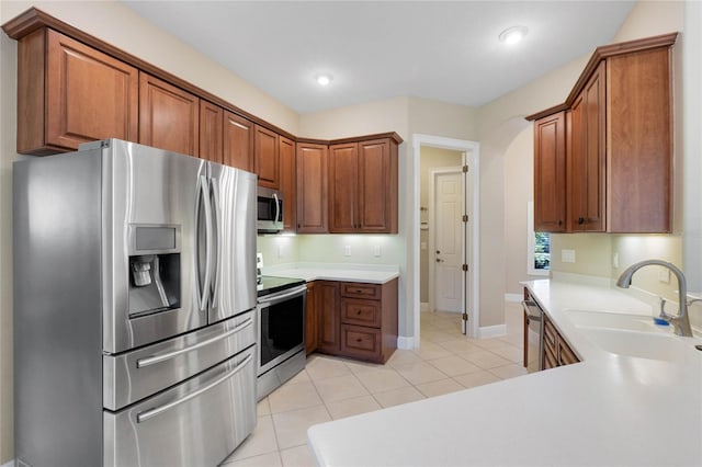 kitchen featuring sink, light tile patterned floors, and stainless steel appliances