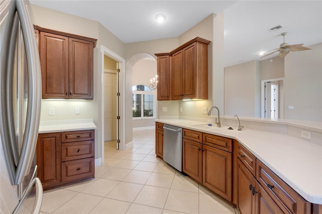 kitchen with sink, light tile patterned floors, stainless steel appliances, and ceiling fan