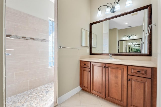 bathroom with vanity, tile patterned floors, and tiled shower