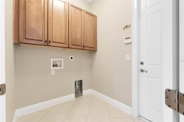 clothes washing area featuring cabinets, washer hookup, hookup for an electric dryer, and light tile patterned floors