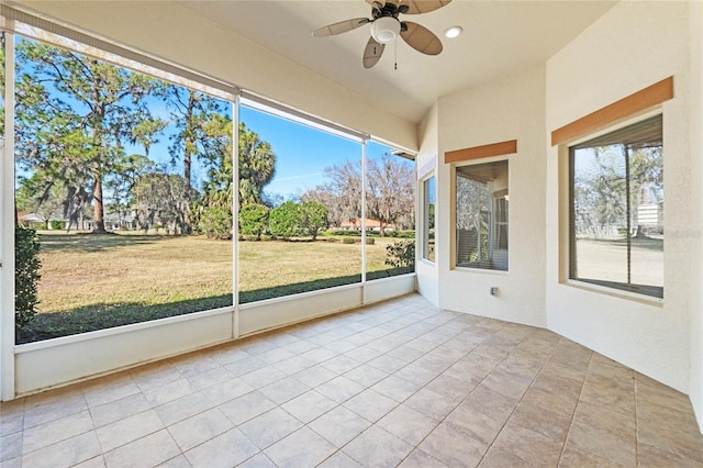 unfurnished sunroom with ceiling fan