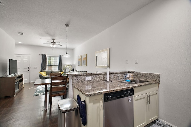 kitchen with sink, white cabinetry, stone countertops, stainless steel dishwasher, and kitchen peninsula