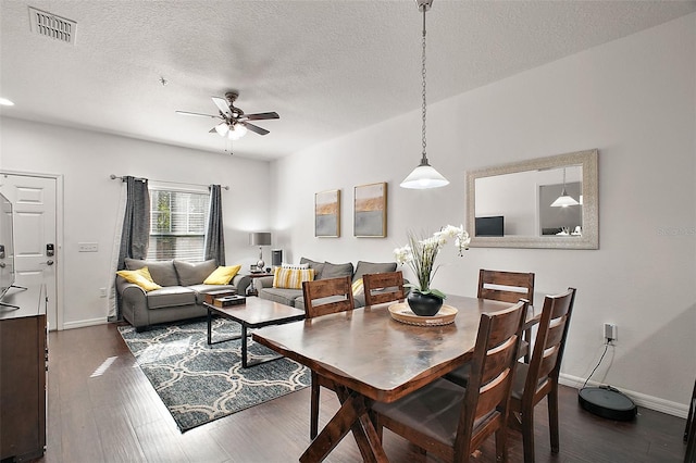 dining space featuring ceiling fan, dark hardwood / wood-style flooring, and a textured ceiling