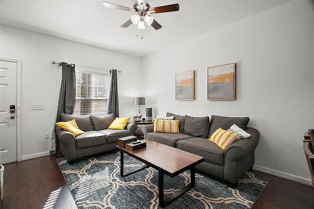 living room featuring dark hardwood / wood-style flooring and ceiling fan