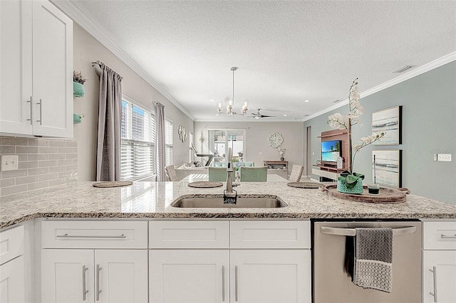 kitchen featuring sink, white cabinetry, light stone countertops, decorative backsplash, and stainless steel dishwasher