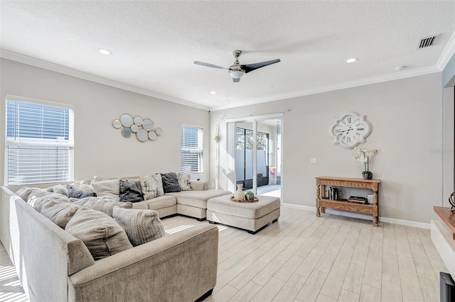 living room featuring ornamental molding, ceiling fan, a textured ceiling, and light hardwood / wood-style flooring