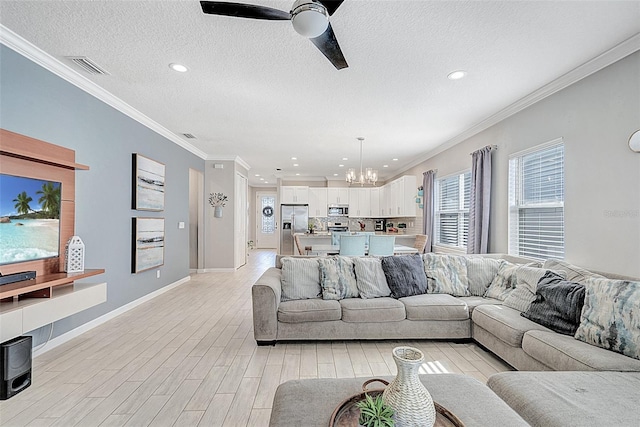 living room featuring ornamental molding, ceiling fan with notable chandelier, a textured ceiling, and light hardwood / wood-style flooring