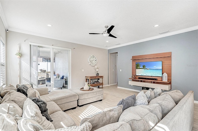 living room featuring ornamental molding, ceiling fan, and light wood-type flooring