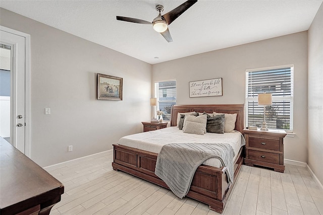 bedroom with ceiling fan and light hardwood / wood-style floors