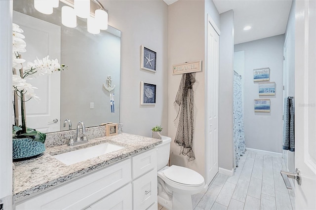 bathroom featuring vanity and toilet