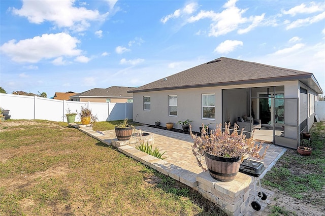 rear view of house featuring a patio area and a lawn