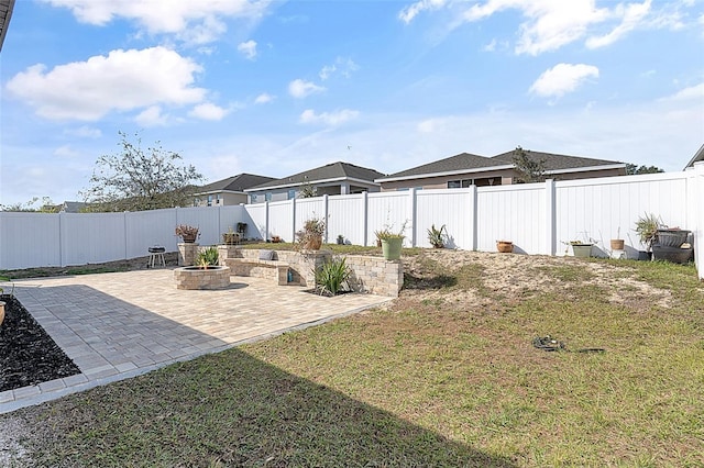 view of yard featuring a patio area and an outdoor fire pit