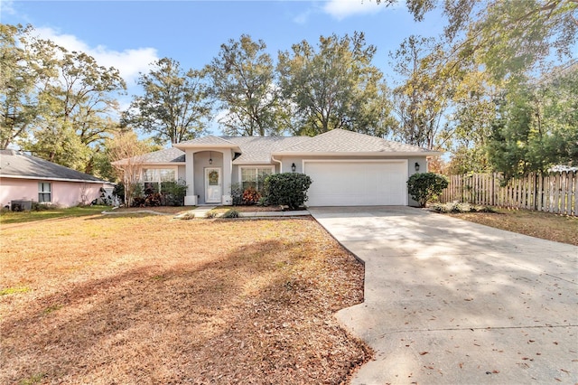 ranch-style home with a garage and a front yard