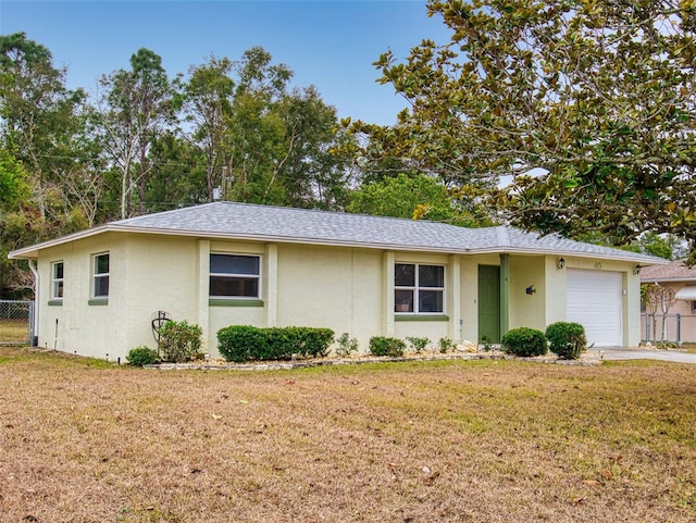 ranch-style home featuring a garage and a front yard