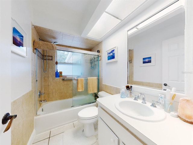 full bathroom with vanity, combined bath / shower with glass door, tile patterned floors, and toilet