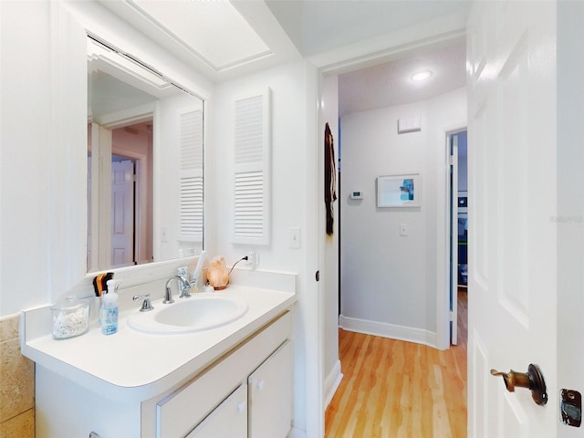 bathroom with vanity and hardwood / wood-style floors