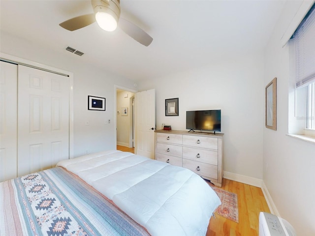 bedroom featuring a closet, ceiling fan, and light wood-type flooring