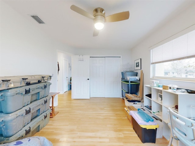 interior space with ceiling fan and light hardwood / wood-style flooring