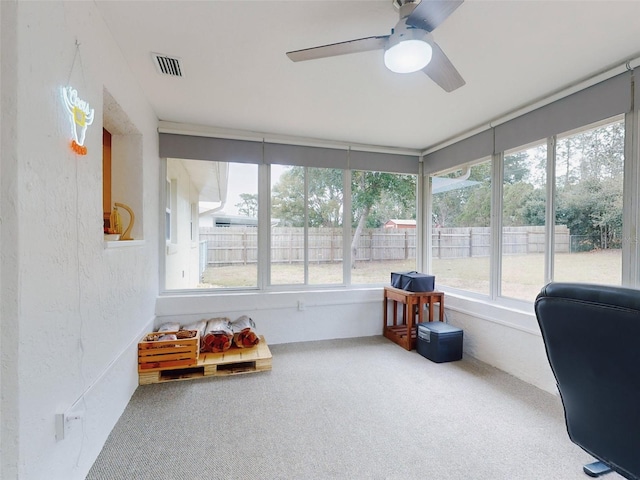 sunroom / solarium featuring ceiling fan