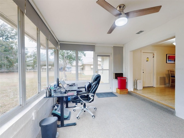 carpeted office featuring a wealth of natural light and ceiling fan