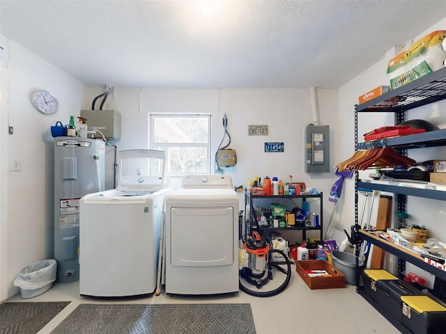 laundry room with washer and dryer, electric panel, and water heater