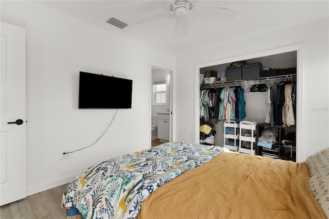 bedroom featuring ceiling fan, light hardwood / wood-style floors, and a closet