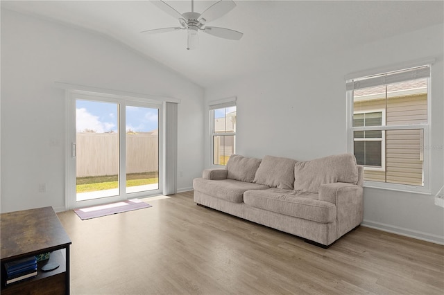 living room featuring light wood-type flooring, lofted ceiling, and ceiling fan