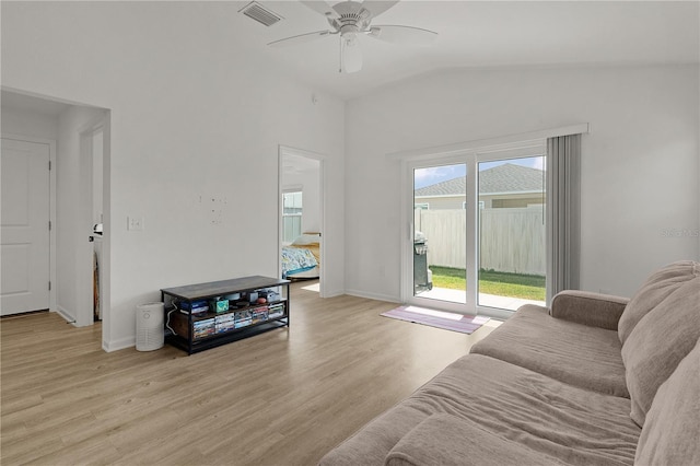 living room featuring ceiling fan, lofted ceiling, and light hardwood / wood-style floors