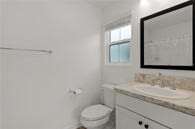 bathroom featuring toilet and vanity