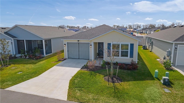 ranch-style house with a garage, central air condition unit, and a front yard