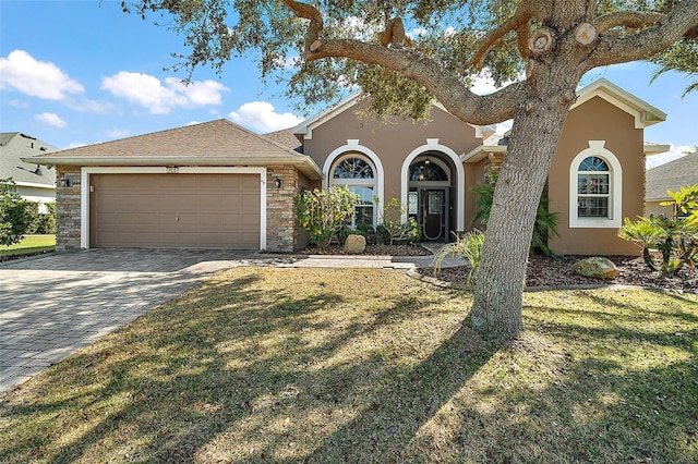 view of front of home featuring a garage and a front lawn