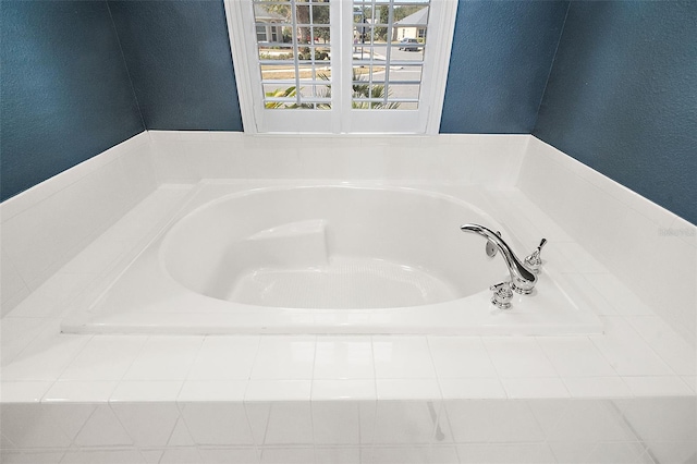 bathroom featuring tiled bath