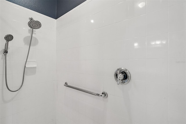 interior details featuring tiled shower