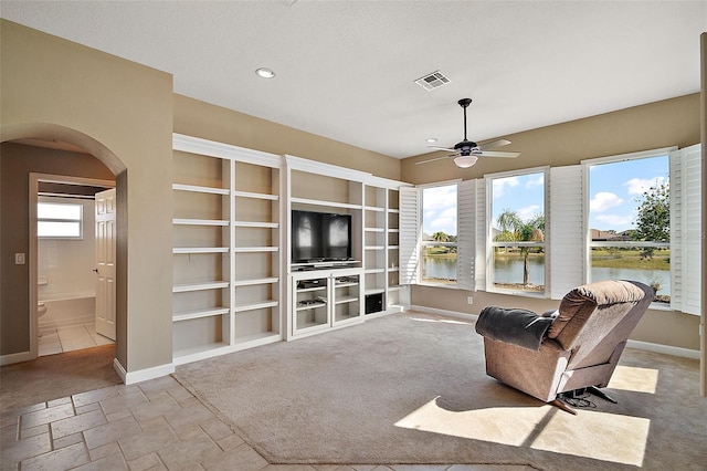 carpeted living room featuring ceiling fan