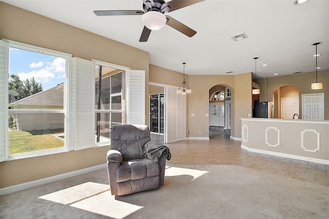 sitting room featuring ceiling fan and light colored carpet