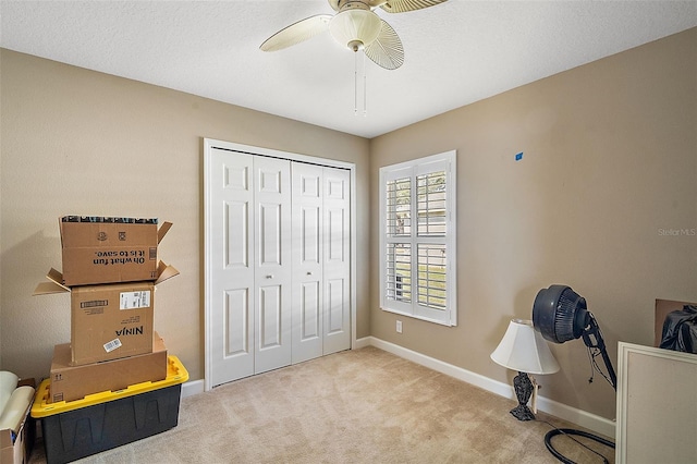 carpeted home office with ceiling fan