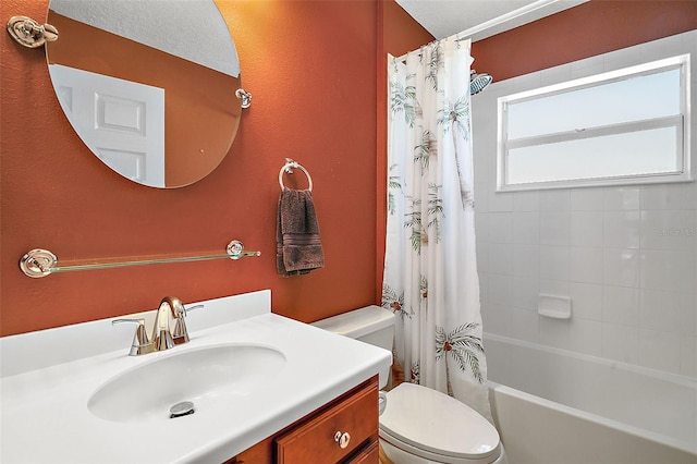 full bathroom with shower / tub combo with curtain, vanity, and toilet